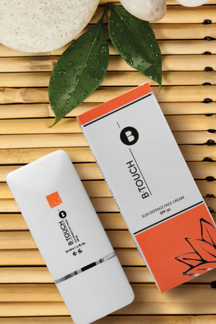 Two green leaves and four white stones on the bamboo mat san defence background e1673613341994